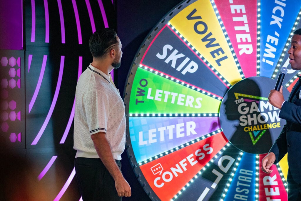 A guest spins a wheel as part of a live game show experience 